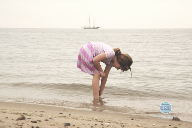girl by the seashore with sailboat